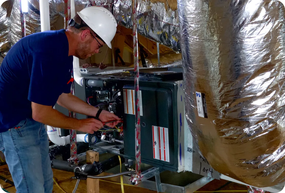 Tempo Mechanical technician wiring an HVAC unit in new construction